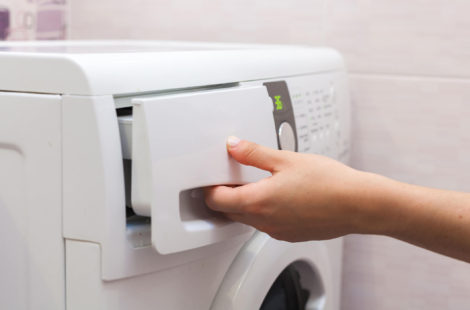 person starting a washer