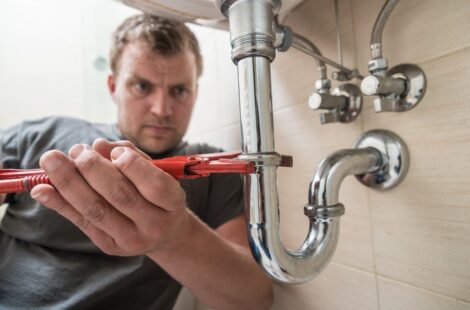 Technician fixing the sink pipe in Seattle home