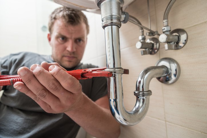 Technician fixing the sink pipe in Seattle home