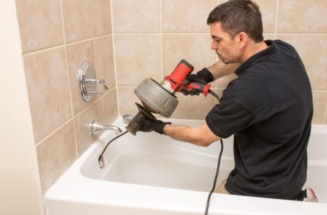 Man fixing a clogged shower drain, WA