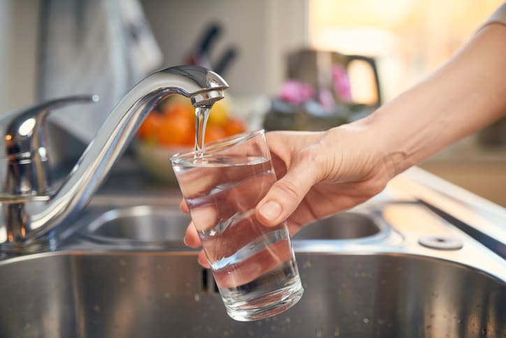 filling a glass of water in the sink