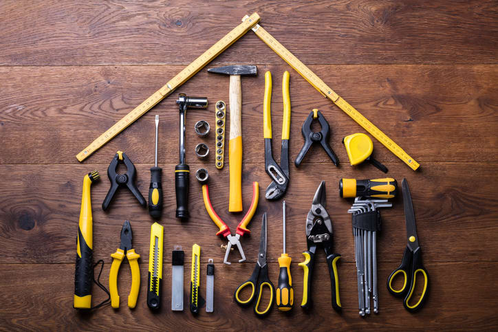 Power tools in the shape of a house laying on a desk