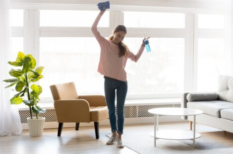 A Woman cleaning living room.