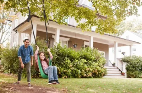 A father pushing his daughter on a garden swing in Seattle, Washington