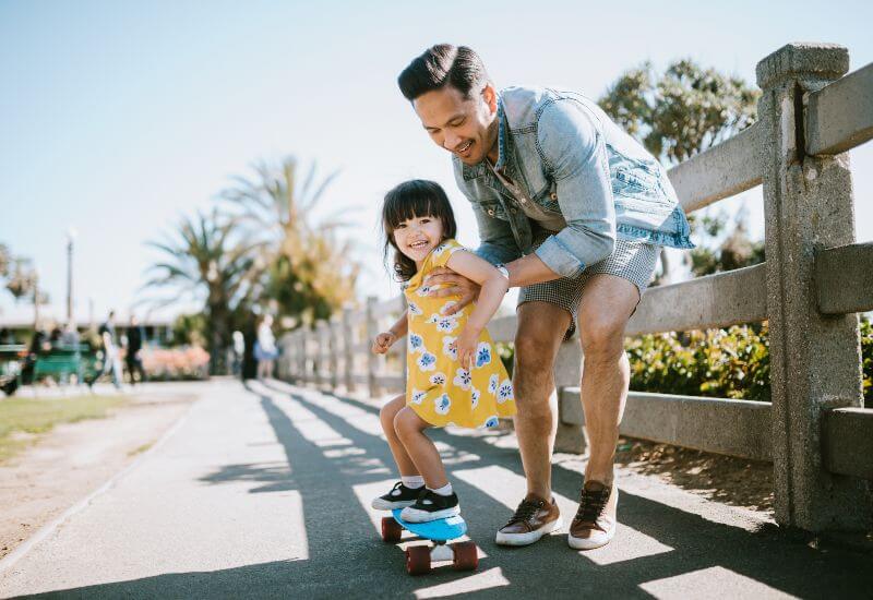 Father and daughter skateboarding