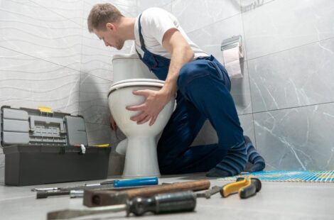Plumbing technician repairing toilet