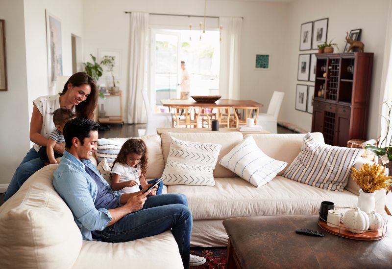 Family of four reading a book