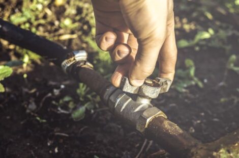 The person opening water tap valve to pour water into a garden at Seattle, WA