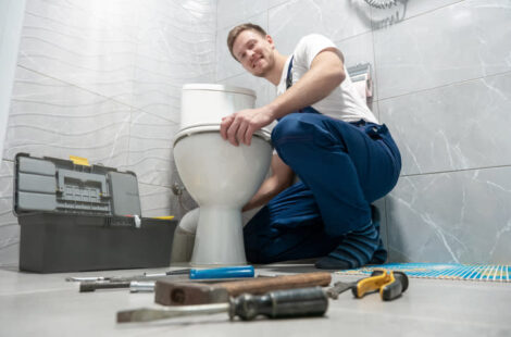 The Man fixing toilet in home at Seattle, WA