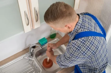 A man using different types of household plungers in Seattle, Washington