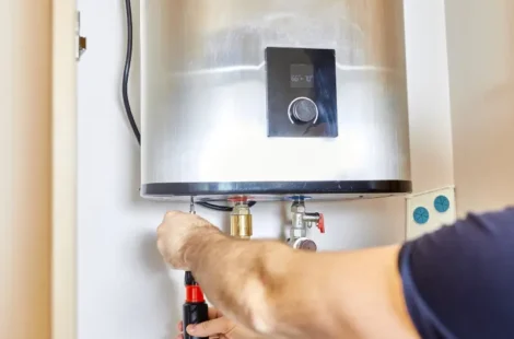 A person repairing a water heater in Seattle, Washington