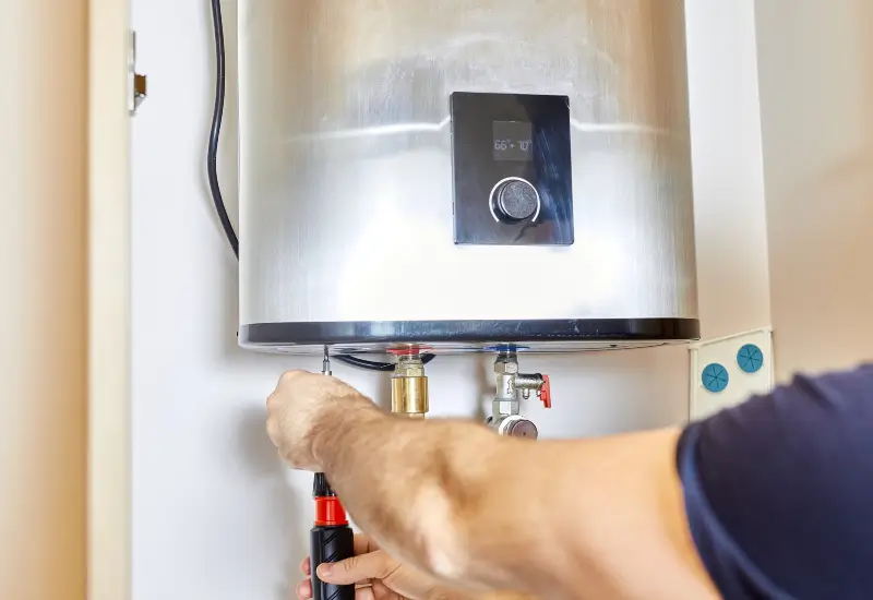 A person repairing a water heater in Seattle, Washington