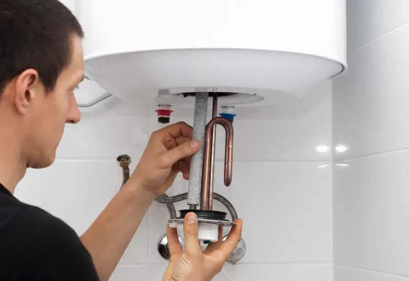 A person replacing a water heater in Seattle, Washington