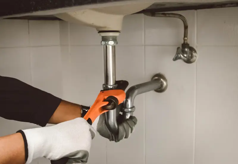 A plumber inspecting a clogged drain in Seattle, Washington